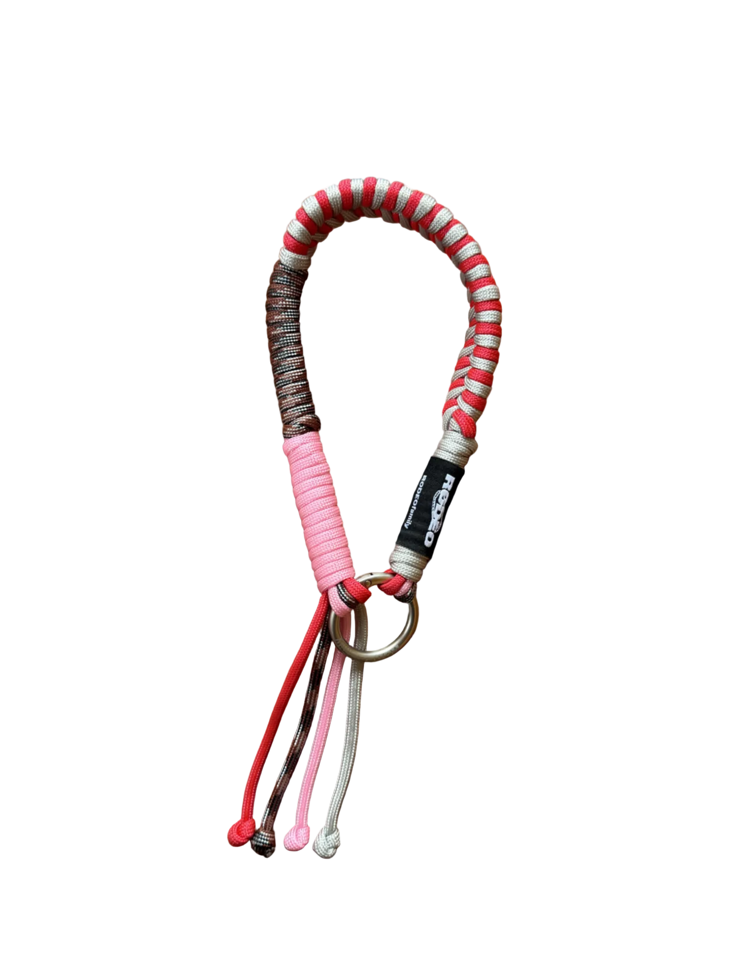 Colorful braided keychain with keys on a brown tiled surface
