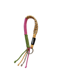 A multi-colored paracord keychain or bag strap with yellow and black woven detailing, a pink coiled section, a green cord section, and a silver metal key ring, shown on a plain white background.